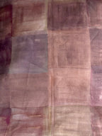 A swatch of plaid fabric with pink and brown colors, displaying the texture and pattern.
