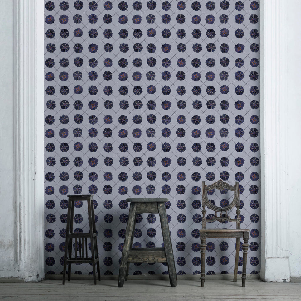 A wallpaper featuring a geometric pattern with floral-like designs in shades of blue on a light background.