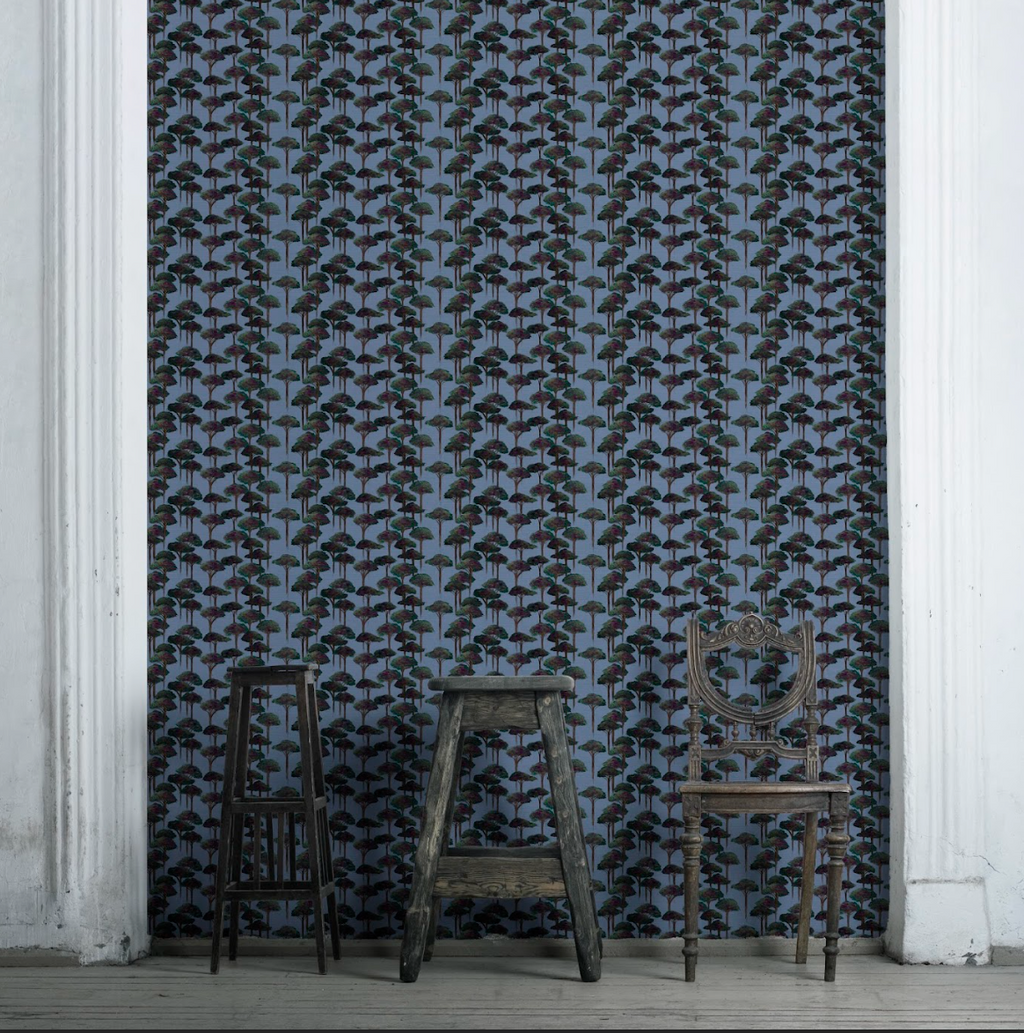 A room with wallpaper featuring a repeating pattern of umbrella-shaped pine trees in various shades of blue, beige, and brown tones. 