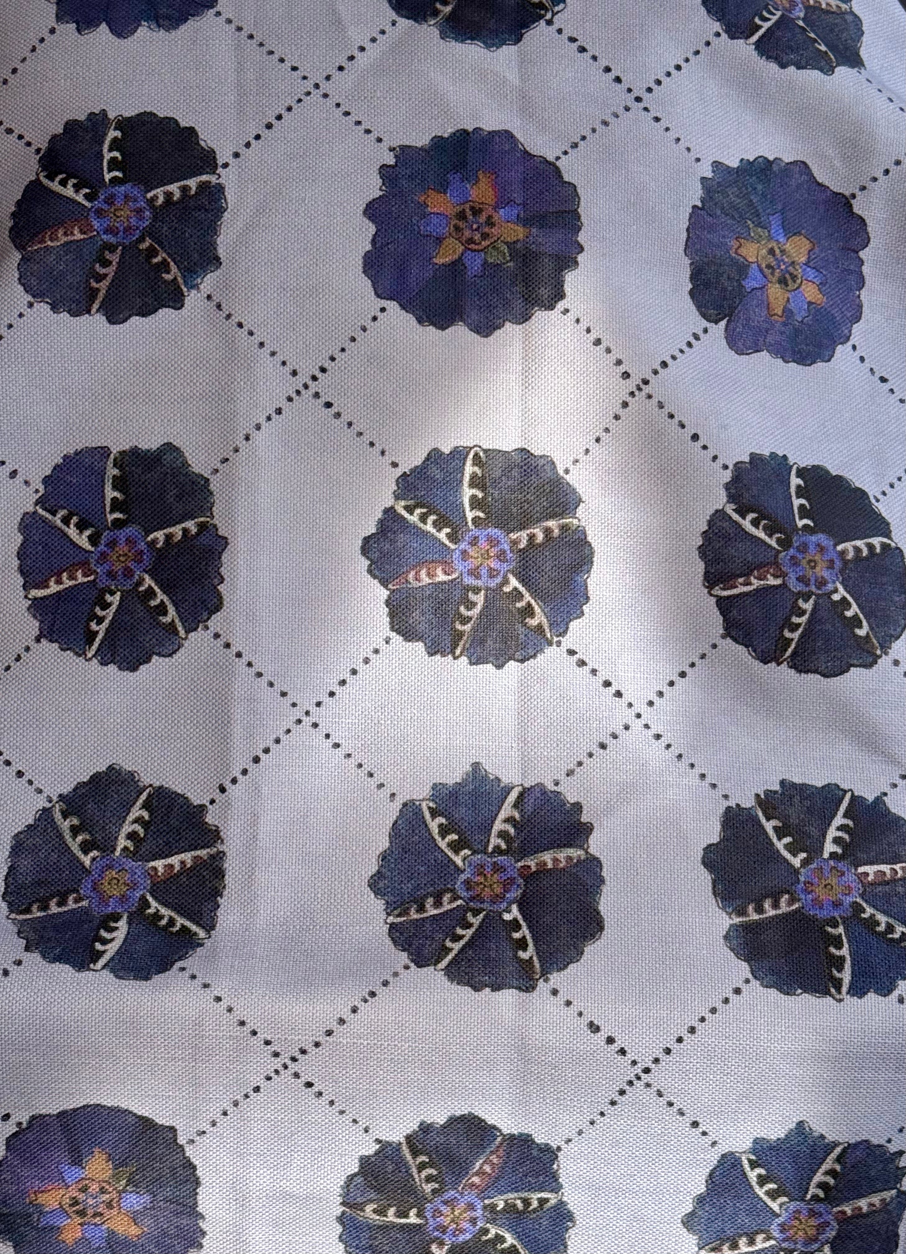 A piece of Suzani fabric with a geometric pattern featuring blue and beige colors, displaying a section of a map.